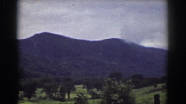 1939: span of countryside terrain with low mountains in the distance