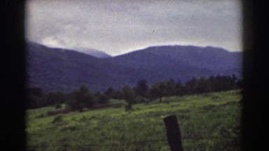 1939: color film of mountain range with barbed-wire fence in the foreground