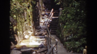 1939: narrow stream flowing near to handrails and stony steps MOUNT WASHINGTON