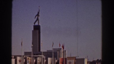 1939: city view with fountain many flags alongside NEW YORK WORLDS FAIR