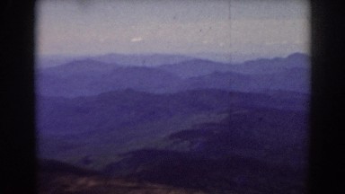 1938: panoramic view of gorgeous blue ridge mountains with lights on the horizon