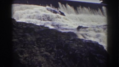1938: a wall of rushing white water cascading over a rocky waterfall
