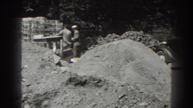 1938: a working site with two men and a black care remains parked CUMBERLAND