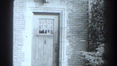 1938: front entry to a brick home with a custom cedar door. CUMBERLAND MARYLAND