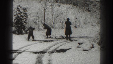 1938: a mother and son get into a snowball fight as the father lights cigarette