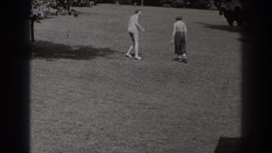 1938: women playing with their dog in the backyard. NEW JERSEY