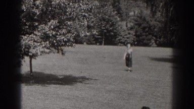 1938: woman and dog return from far end of a yard. NEW JERSEY