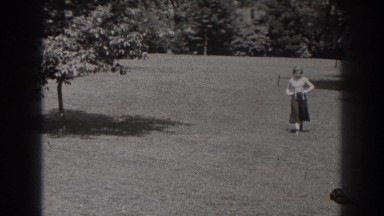 1938: woman playing with her dog in the yard. NEW JERSEY