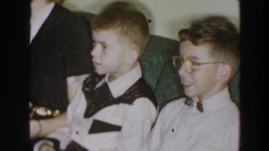 1957: Group of Children and Adults Dressed Nicely Laughing on Couch in Wheeling, Ohio