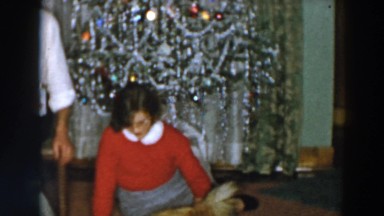1957: Woman Playing With Her Animals On Christmas Morning, Wheeling Ohio
