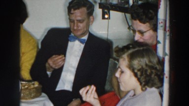 1957: a group of people at a semi formal get together at a dessert table