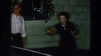 1957: a group of friends having a ping pong match at a christmas party WHEELING