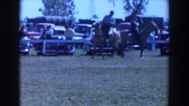 1957: several people on horseback are observed by others who wander around