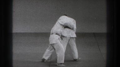 1971: two young men perform karate moves, stand and face each other