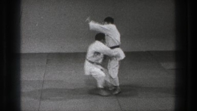 1971: two men in white karate uniforms demonstrating a karate move TOKYO JAPAN