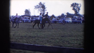 1957: horses enjoying taking a stroll with their owners as people watch them