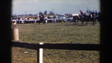 1957: a rider and horse are circling the arena at a gallop in a barrel