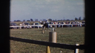1957: cowboy on horse tries to hit his flag mark. WHEELING OHIO