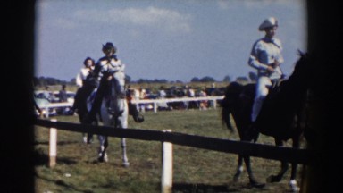 1957: cowboys and a cowgirl riding their horses at a rodeo WHEELING OHIO