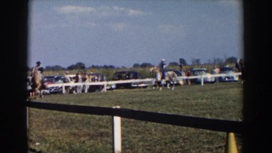 1957: men riding horses enjoying the day people watching standing by cars