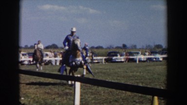 1957: cowboys riding horses at a rodeo WHEELING OHIO