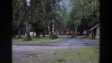 1964: a campground built around a paved circular road resides in a forested area