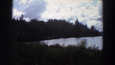 1964: thunder clouds forming over a pristine mountain lake. CALIFORNIA