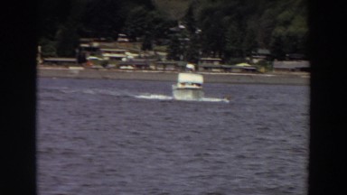 1964: a boat crossing calm water just off the shore. WASHINGTON