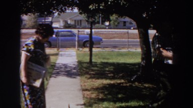 1964: woman walking casually on the sidewalk. WASHINGTON