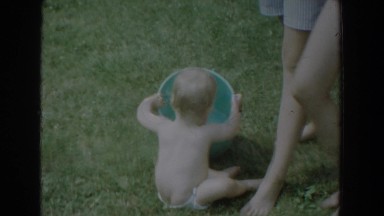 1965: a baby playing with a bucket and a group of kids swimming in water.
