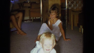 1965: adorable baby crawling, then sitting in a bucket of water in the backyard