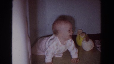 1965: baby is on hands and knees in corner and sitting in bathtub