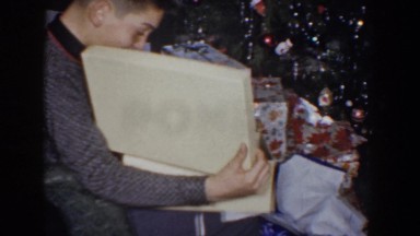 1960: an excited kid opening his presents on christmas morning BEL AIR MARYLAND