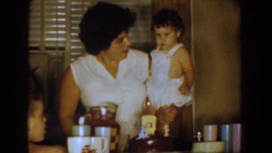 1960: a woman holding a baby at the dinner table BEL AIR MARYLAND