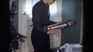 1960: boy opens electrical engineering gift at christmas BEL AIR MARYLAND