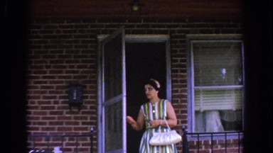 1960: a woman steps out the door of a house BEL AIR MARYLAND