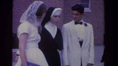 1960: special occasion with couple dressed up and posing with a nun BEL AIR