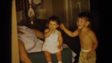 1960: cute toddler kids playing with grandma indoors BEL AIR MARYLAND