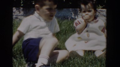 1960: 2 children sitting on grass. enjoying the beautiful day