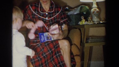 1965: woman gives young child a new pink toy telephone FALLSTON MARYLAND