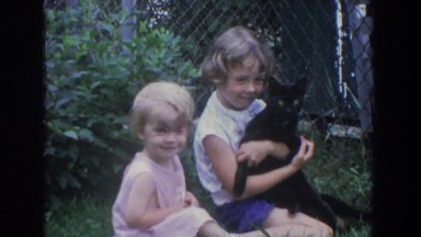 1965: little girls sitting outside playing with black cat FALLSTON MARYLAND