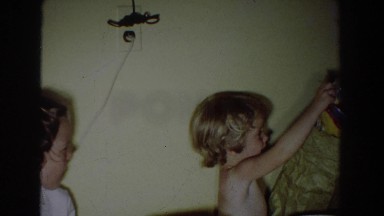 1965: small child receives birthday presents, including bubbles, books