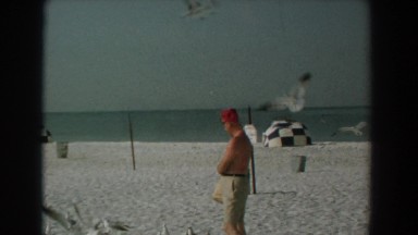 1958: a man feeding seagulls at the beach YORKTOWN VIRGINIA
