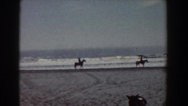 1958: friends riding horseback along the ocean shore. YORKTOWN VIRGINIA