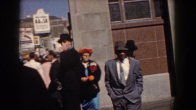 1958: a pretty women keep smiling and walking on the busy street YORKTOWN