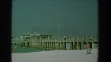 1958: graffiti and signage painted along the pier. YORKTOWN VIRGINIA