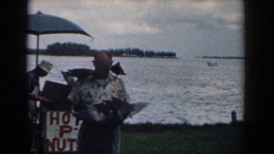 1958: person enjoying the outdoors and playing with animals near the water