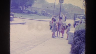 1961: A Group of Children Standing and Talking on a Sidewalk in Ireland