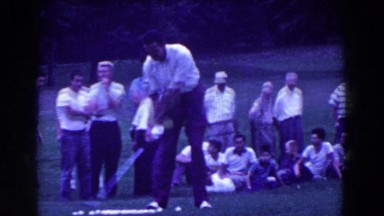 1961: Man Playing Golf on a Nice Day While Being Watched Carefully by Spectators
