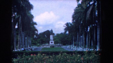 1958: A Man Walking in a Park with Monument in Background